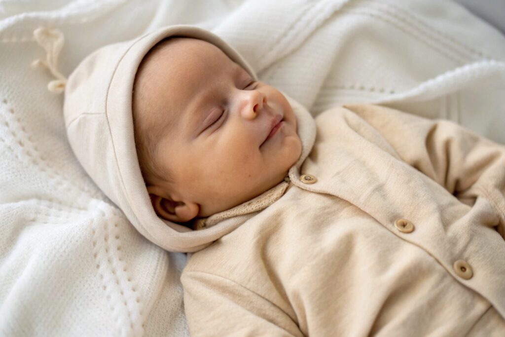 Baby dressed in organic cotton hooded romper