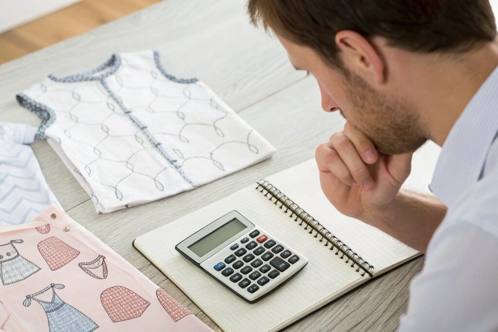 Business owner calculating textile costs