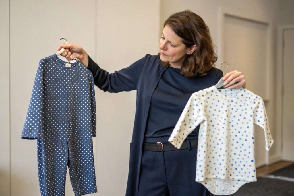 Business owner comparing babywear designs
