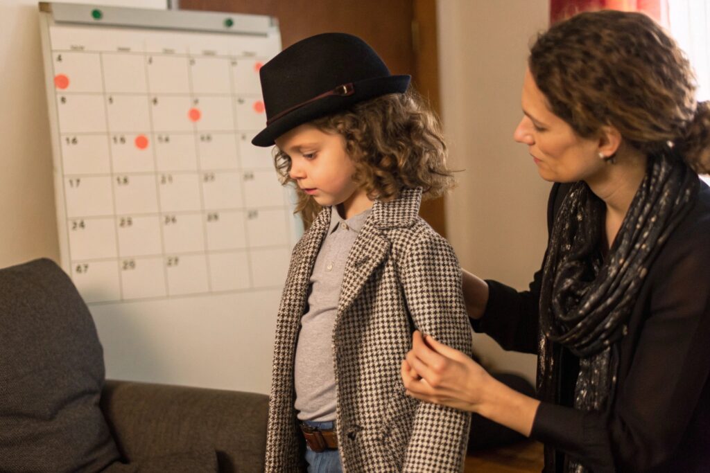 Parent helping child prepare for a fashion shoot