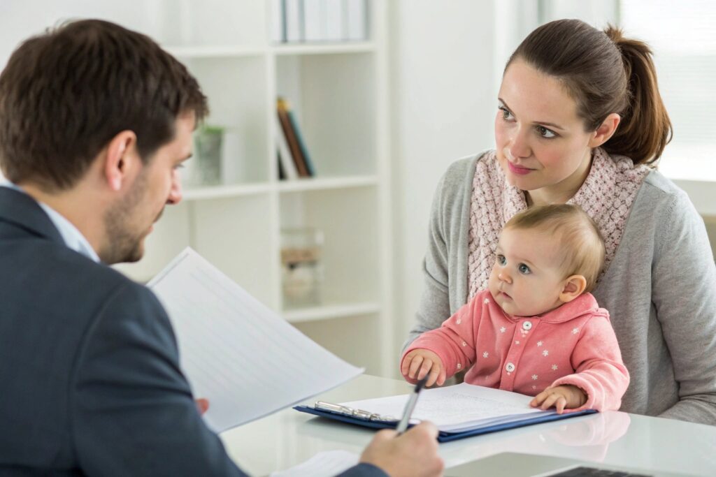 Parent discussing baby clothing order with manager