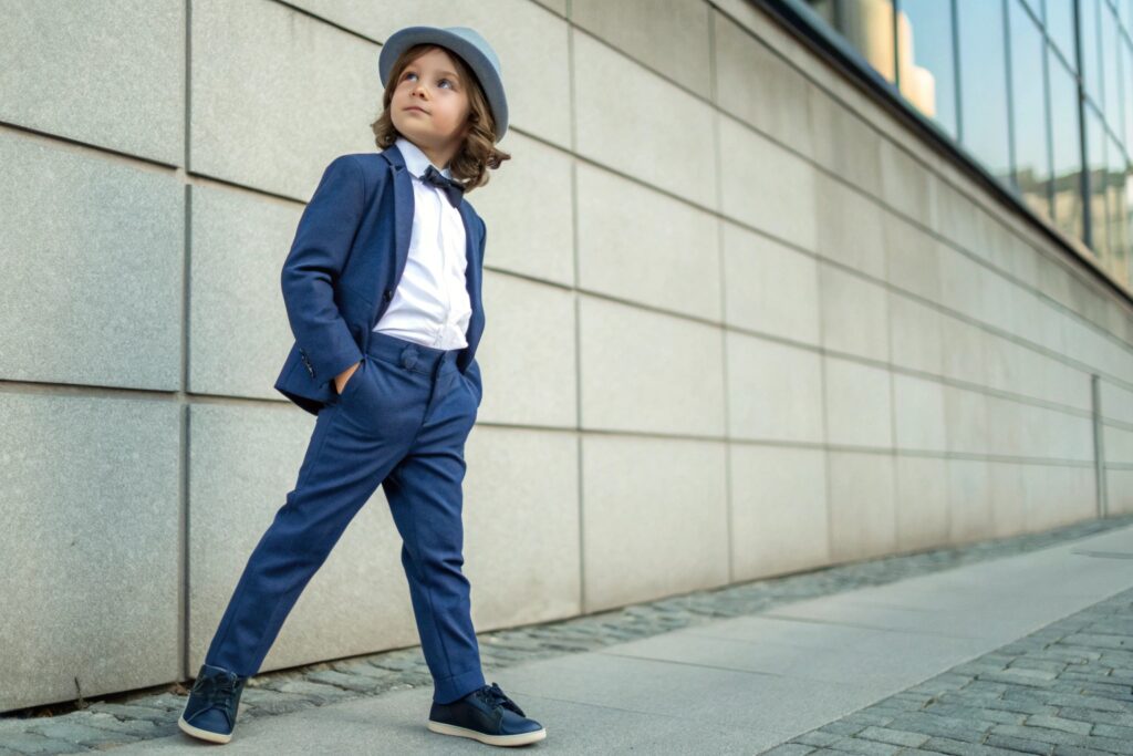Young boy in a stylish slim-fit blue suit with bow tie