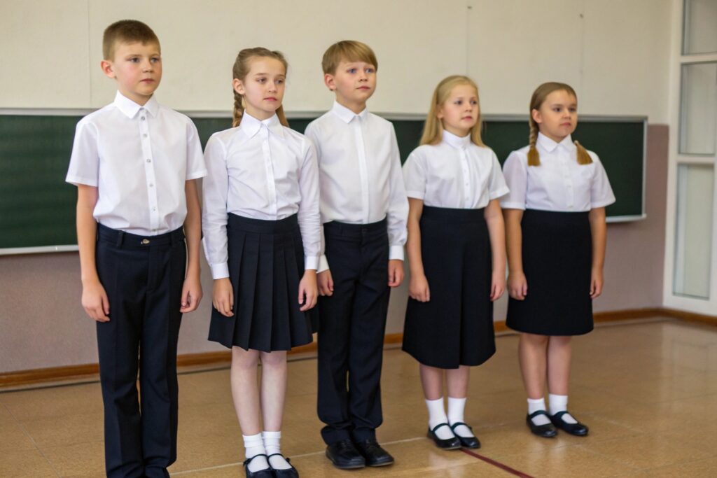 Group of children in formal school uniforms in classroom
