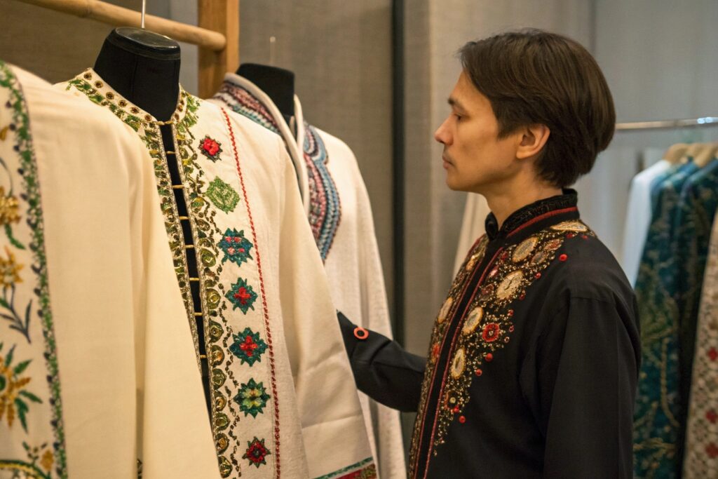 Business owner admiring traditional clothing