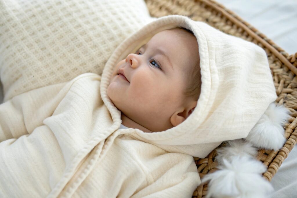 Baby wearing organic cotton hoodie in cozy setting