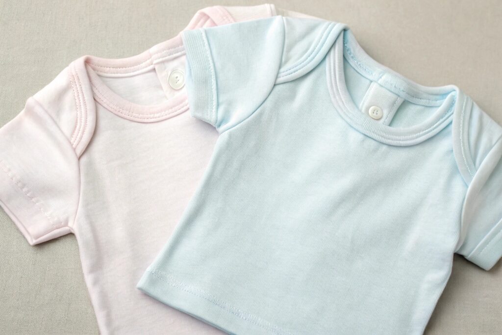 Two soft baby t-shirts, one pink and one blue, showcasing gentle fabric and design