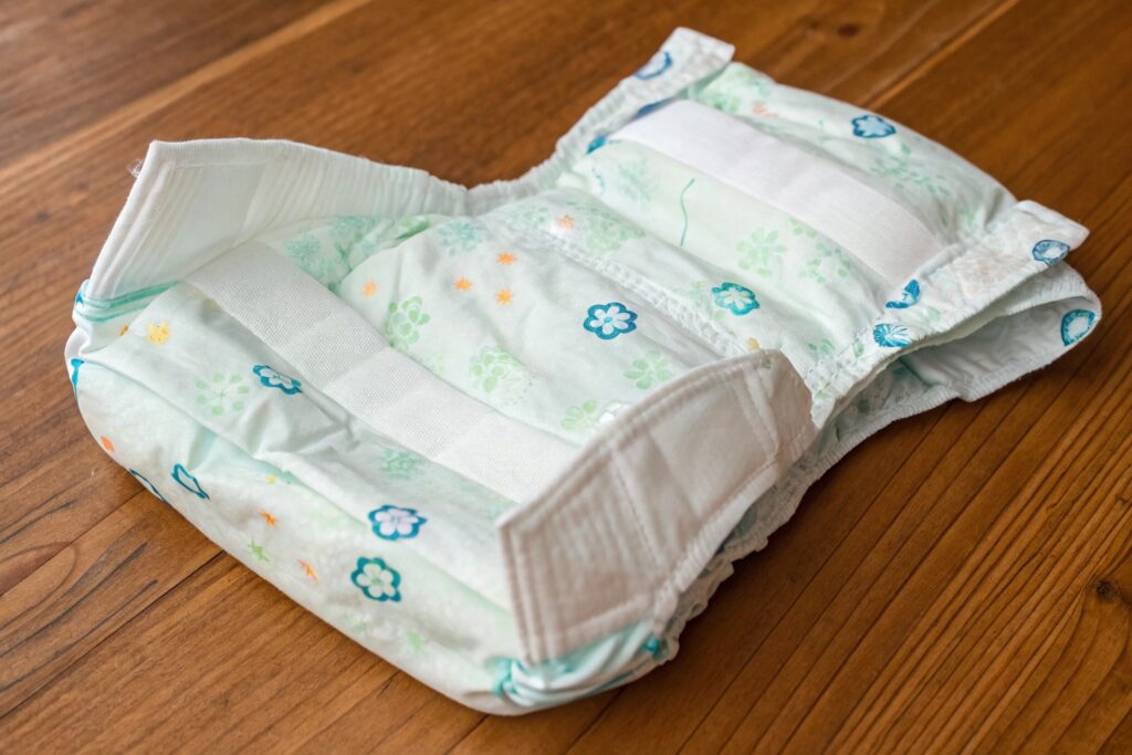 Youth-sized diaper with floral print on wooden surface