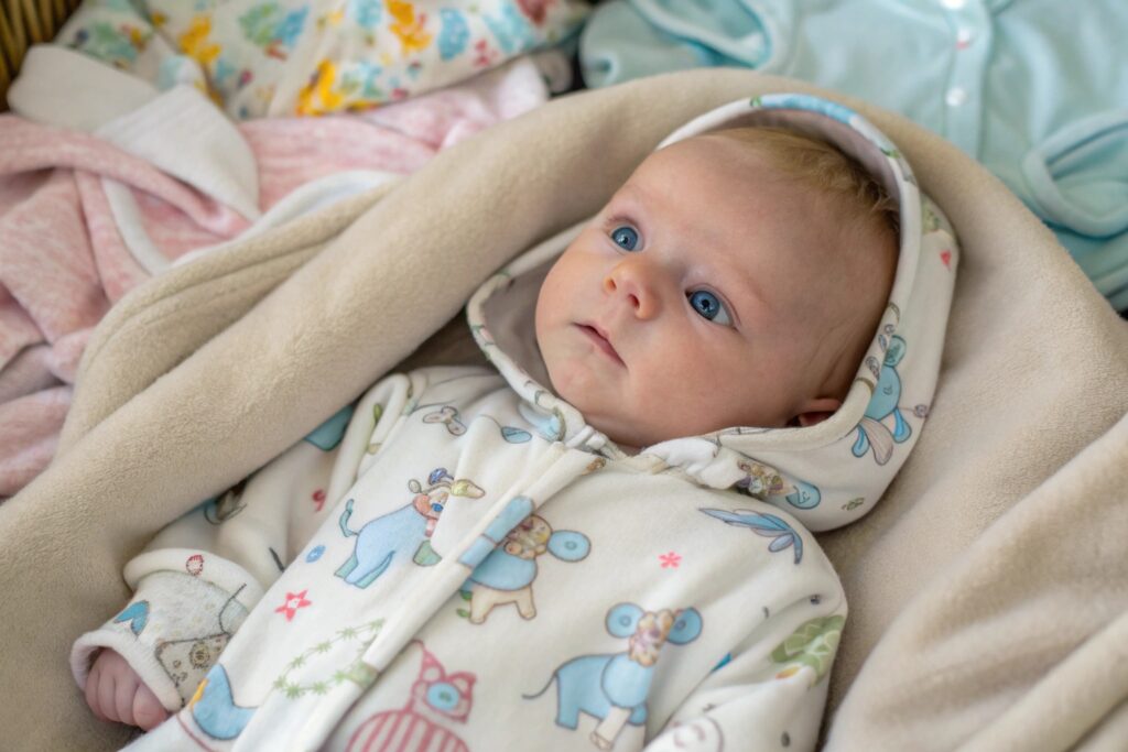Baby wearing a onesie with a custom print