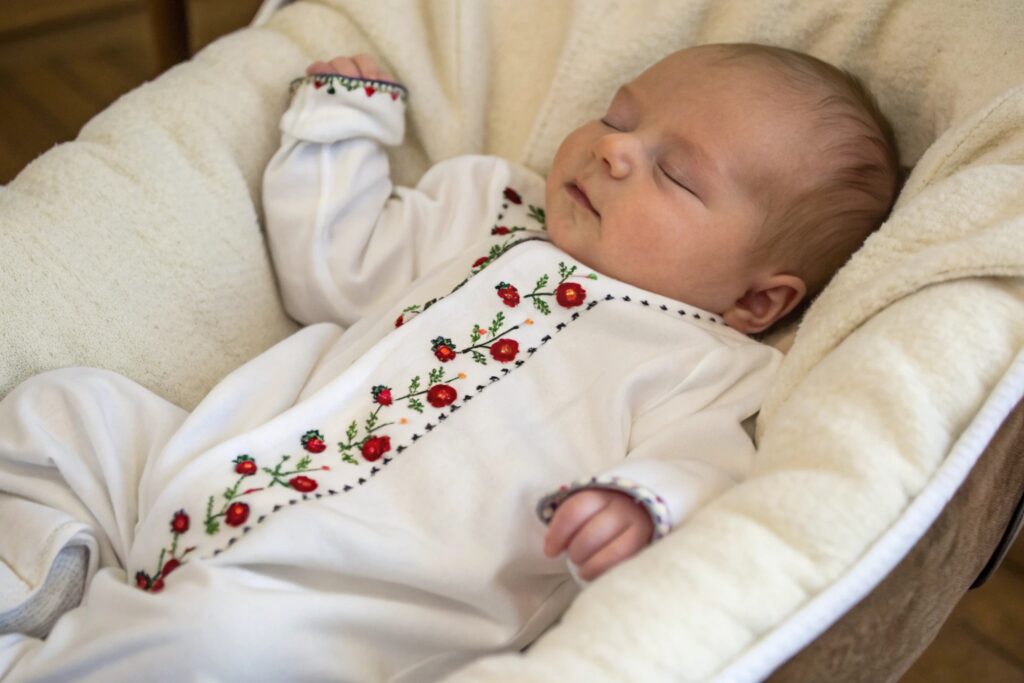 Baby wearing a romper with custom embroidery