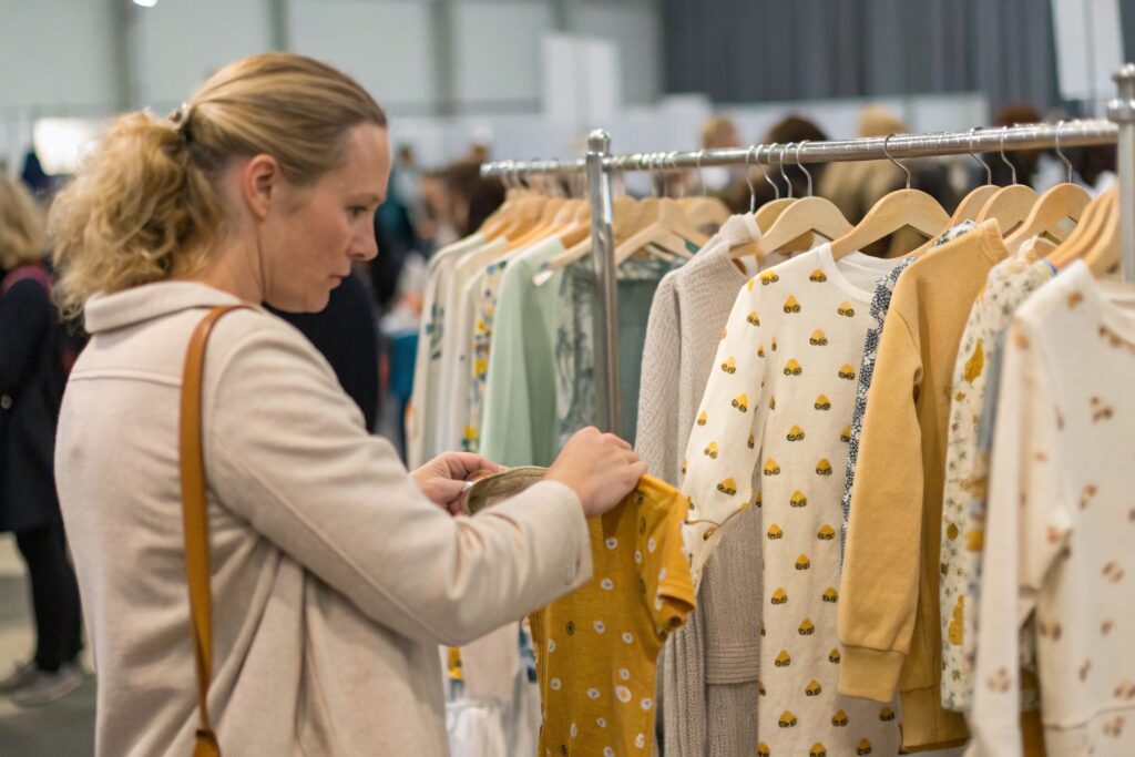 Buyer examining kidswear samples at Canton Fair