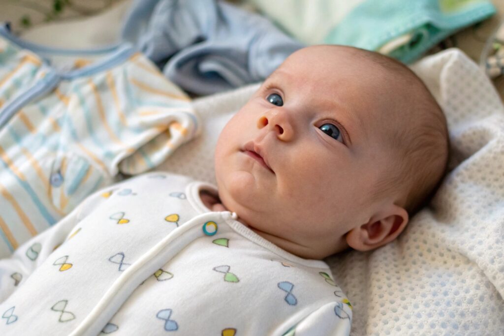 Close-up of a newborn wearing organic babywear