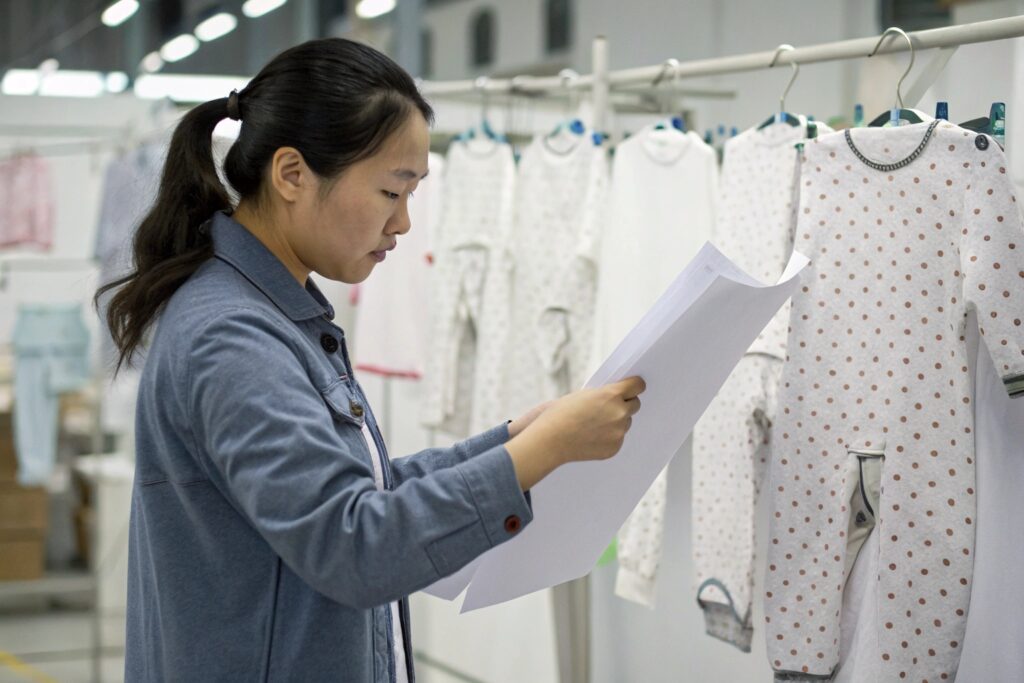 Chinese worker reviewing production details in a factory