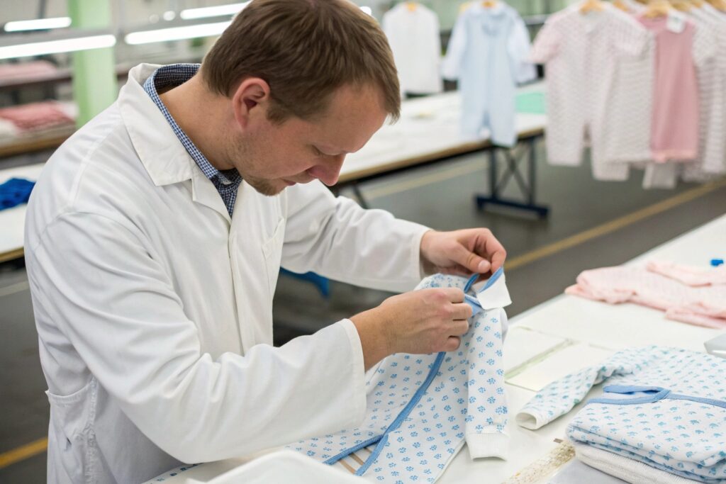 Factory worker adjusting a sample for production