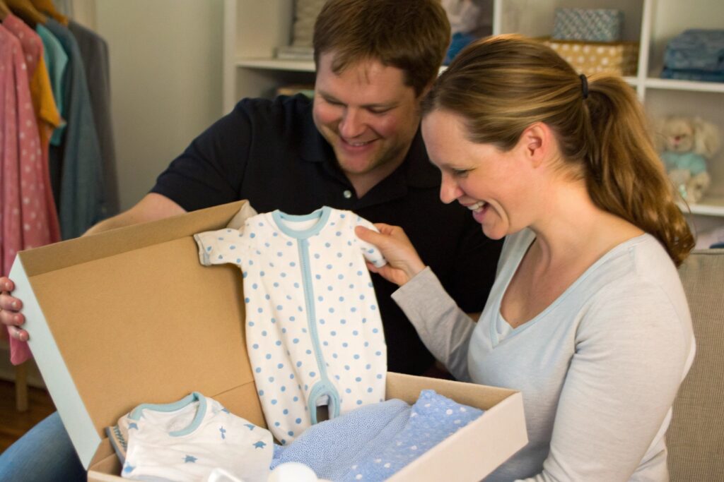 Family opening a gift of personalized babywear