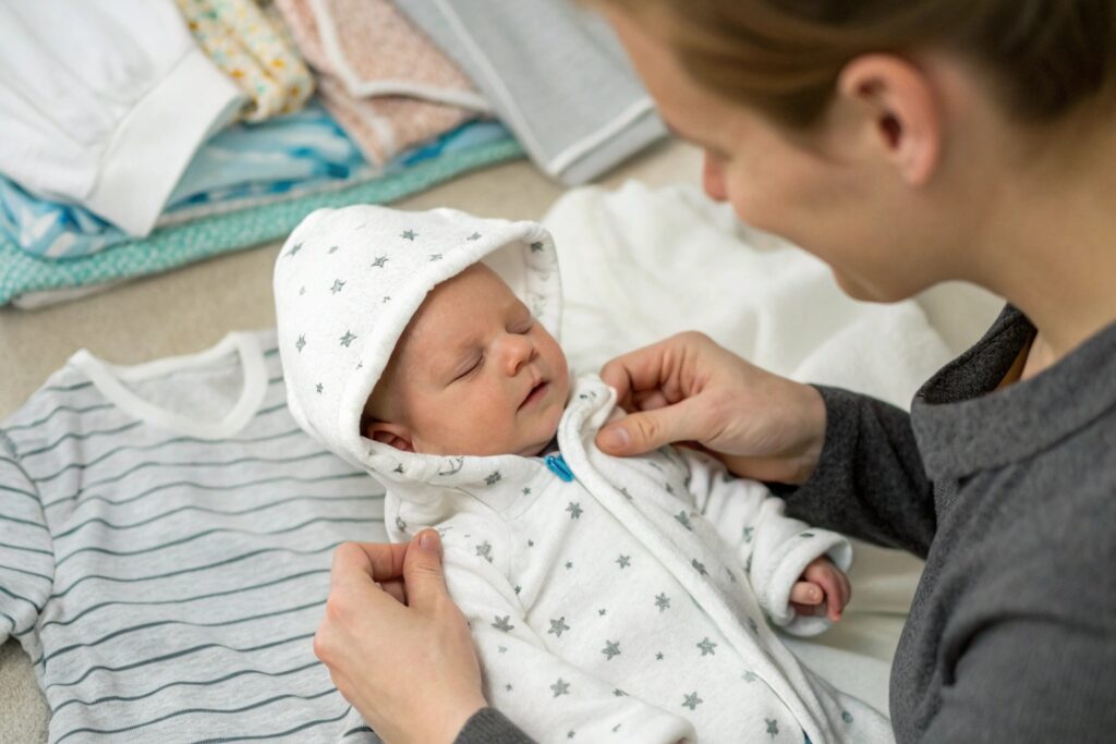 Parent dressing their baby in a personalized outfit