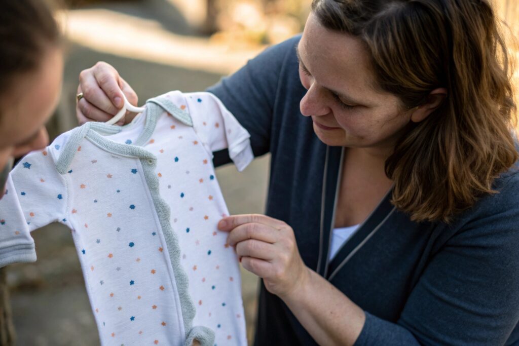 Parent Holding a Personalized Baby Onesie