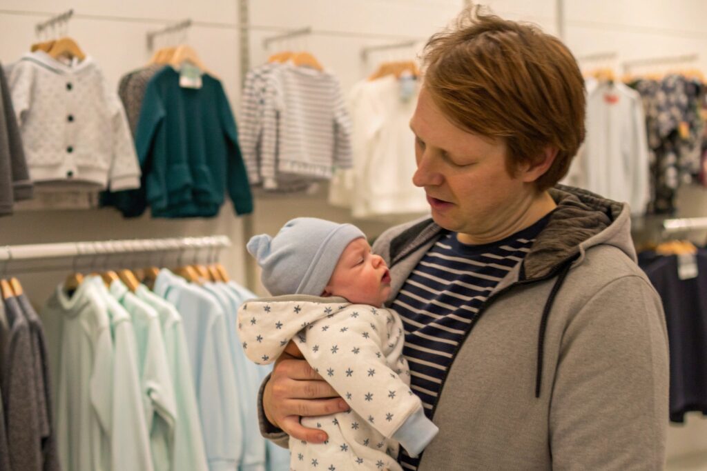 European Parent Trying on Babywear Garment