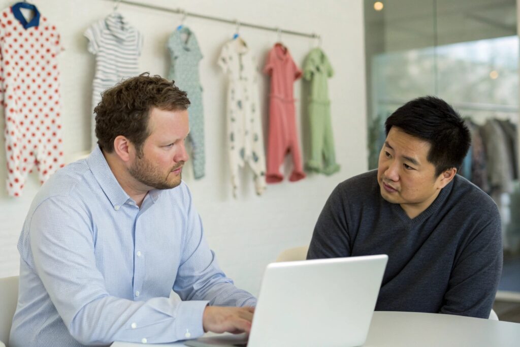 Sourcing agent discussing business with colleague