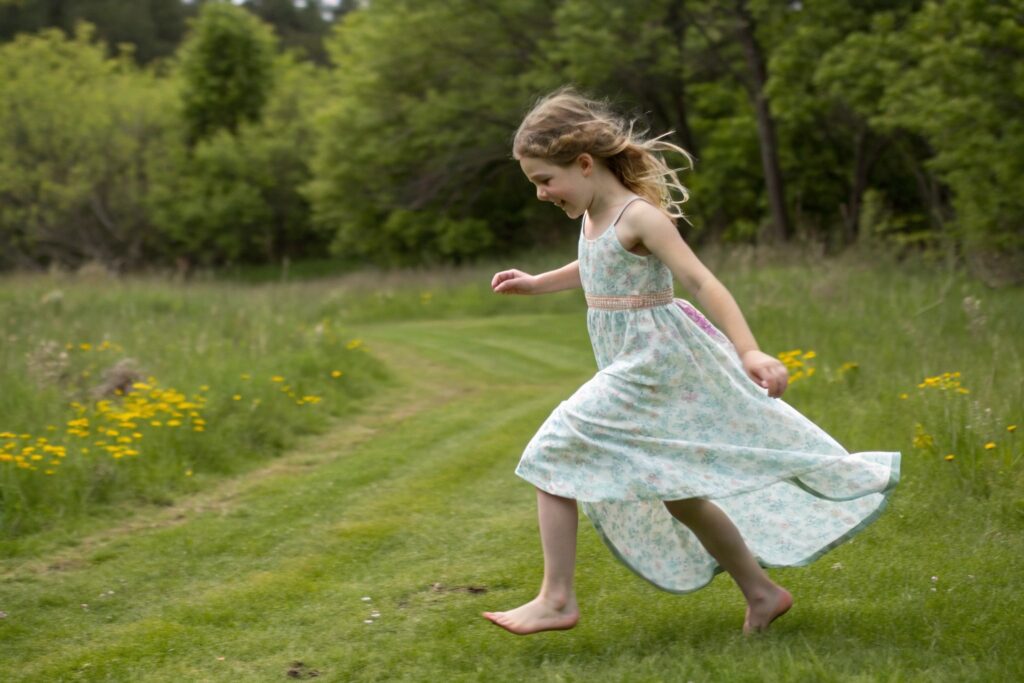 Young European girl running and playing outdoors