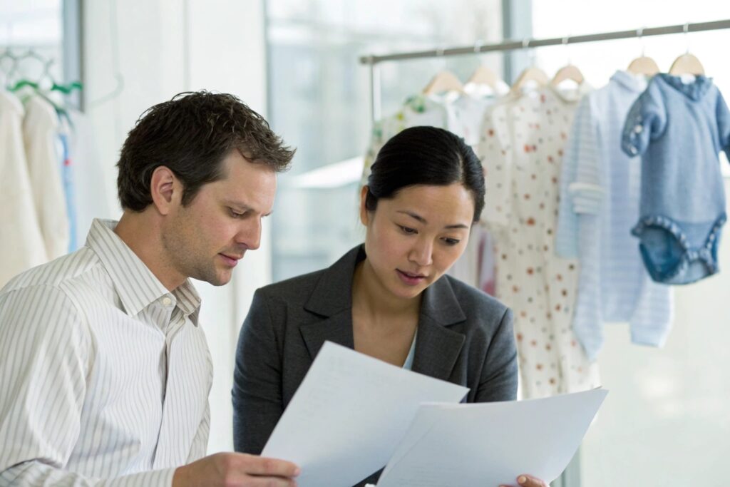 Business owner and customs expert reviewing documents