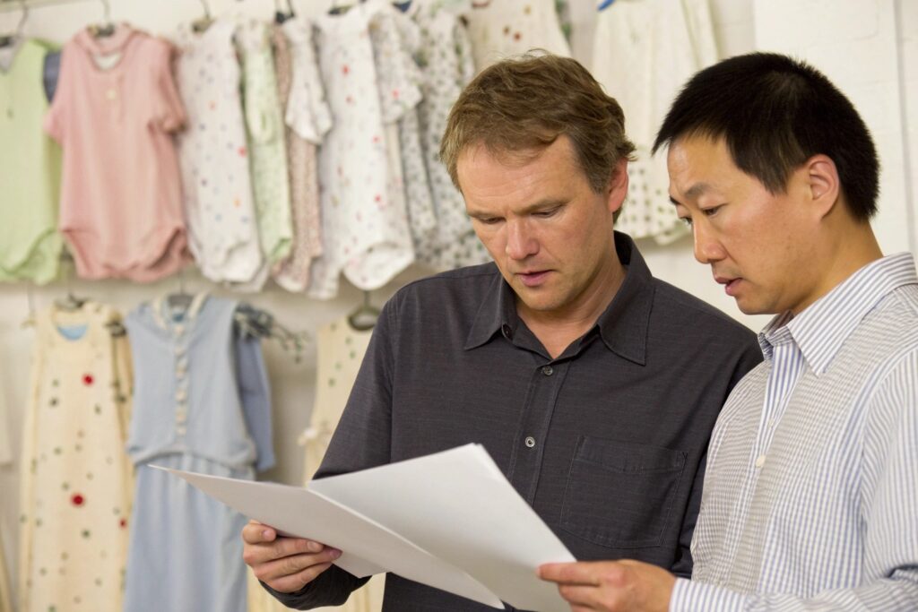 Business owner and customs expert reviewing documents