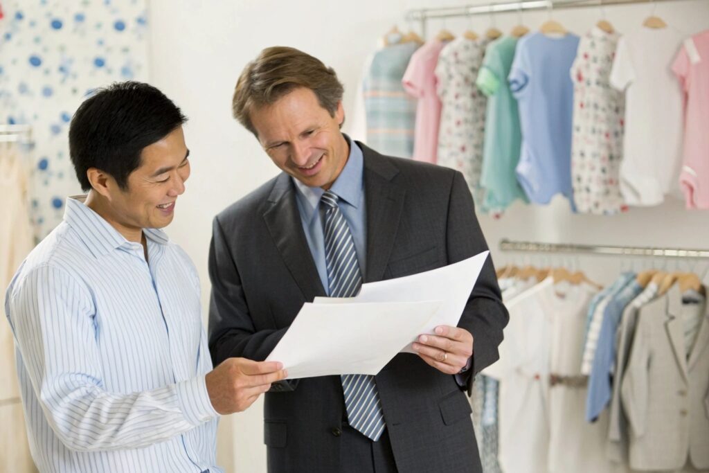 Business owners reviewing the clothing designs