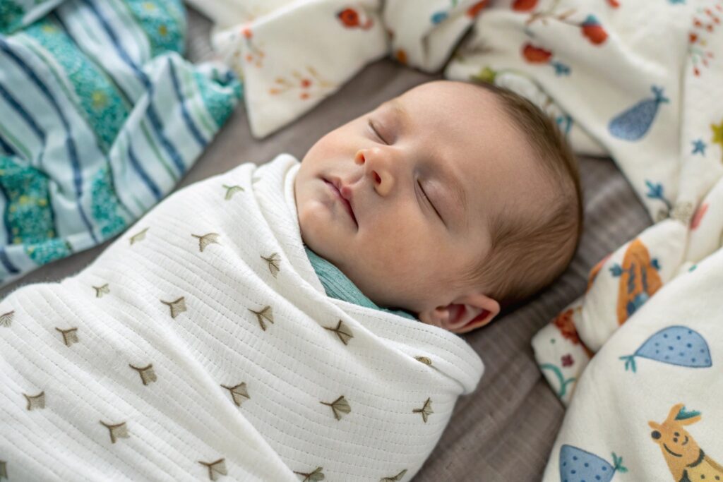 Newborn wrapped in a soft, breathable cotton blanket
