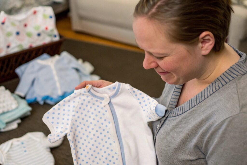 Parent holding personalized babywear
