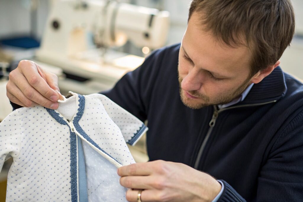 Quality control specialist inspecting zipper on baby garment