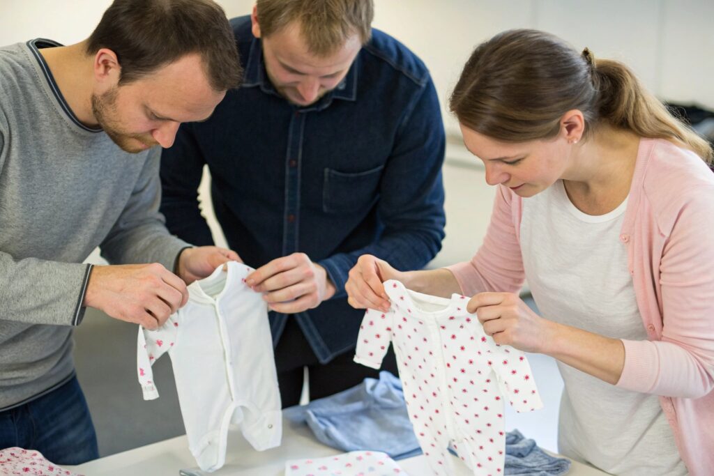 Quality control team inspecting babywear designs