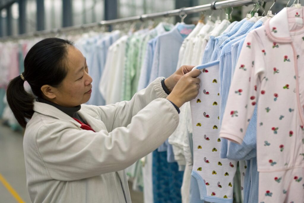 Inspector Checking Babywear Quality in Factory