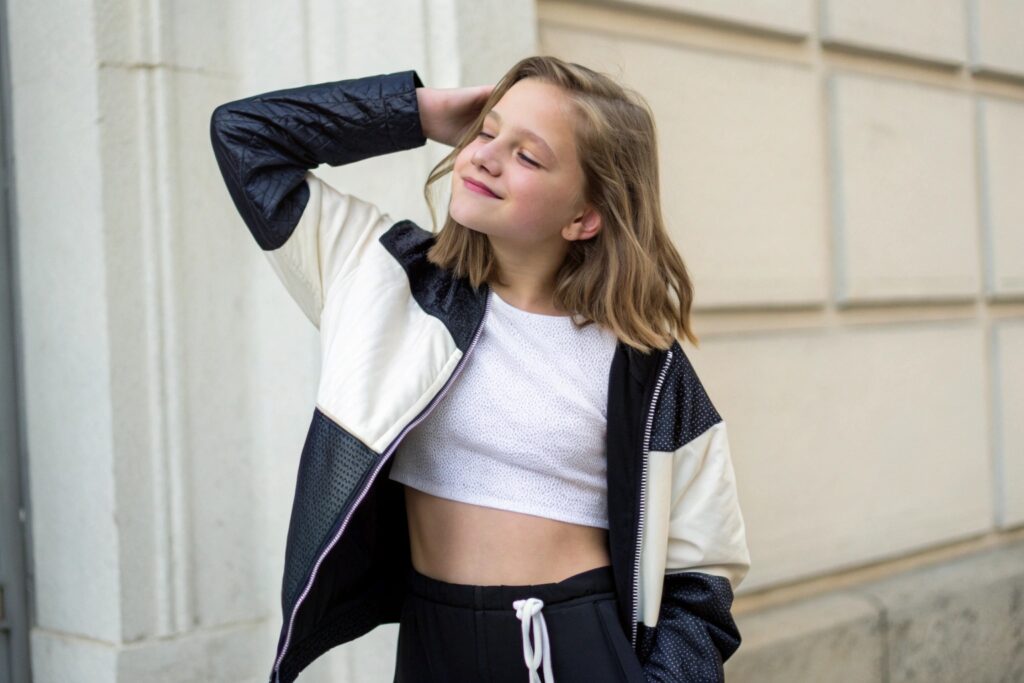 Teenage girl wearing a crop top and jacket
