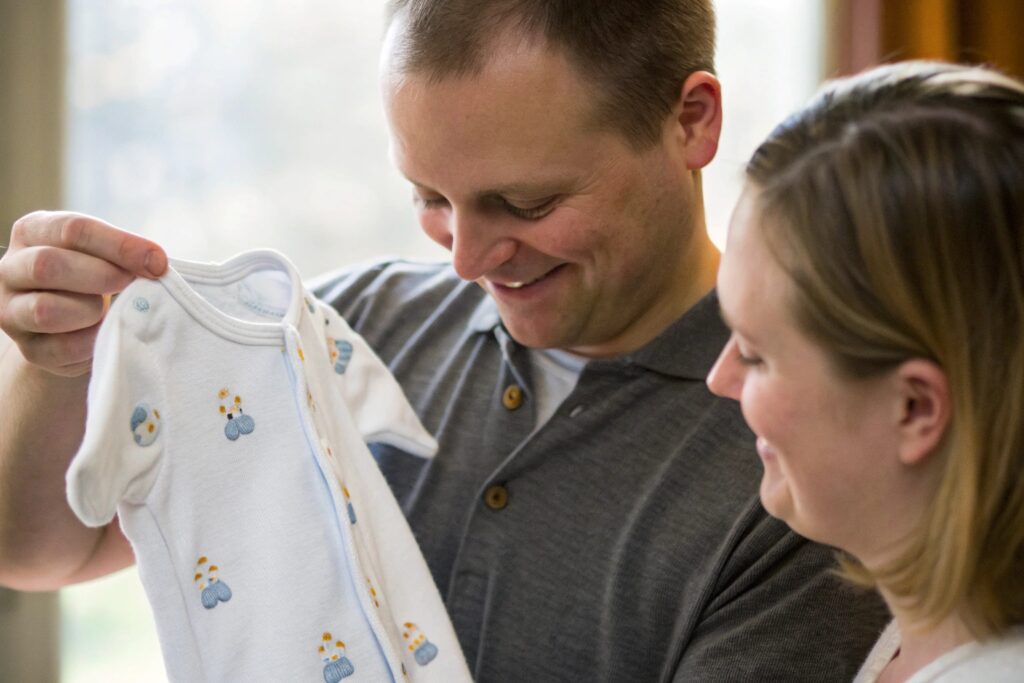 Parent admiring a personalized baby outfit