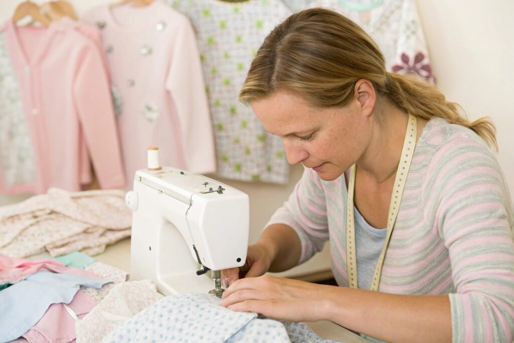 Seamstress sewing baby clothes