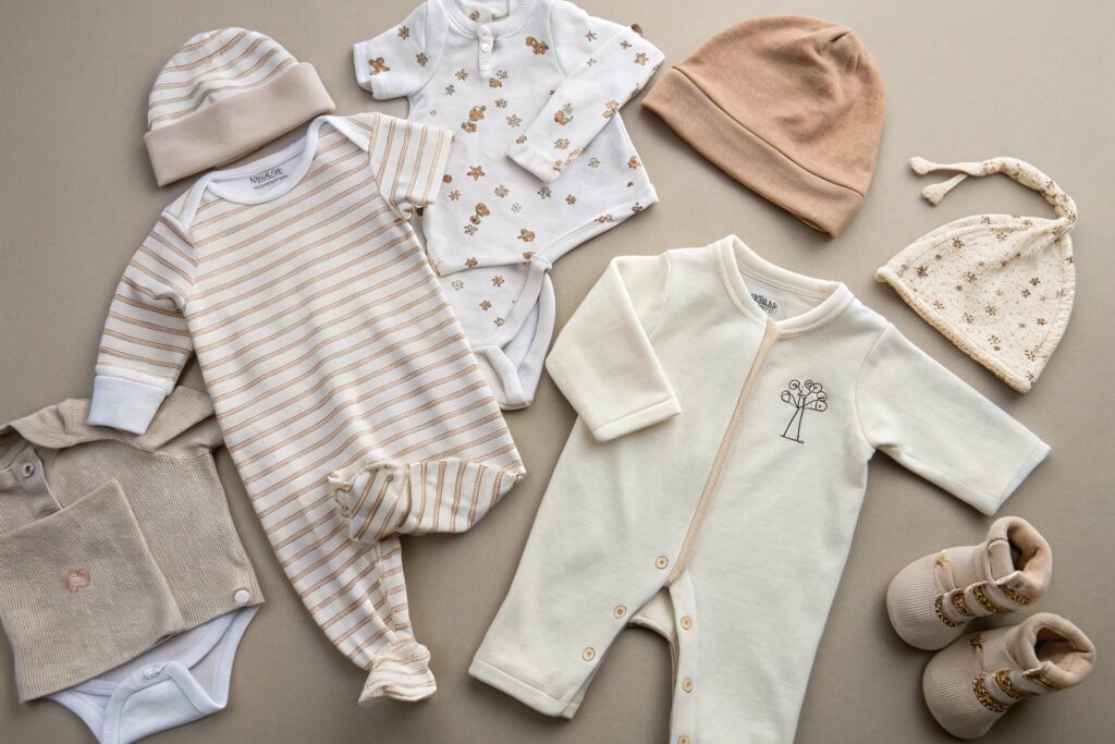 baby clothes set with onesies, hats, and booties